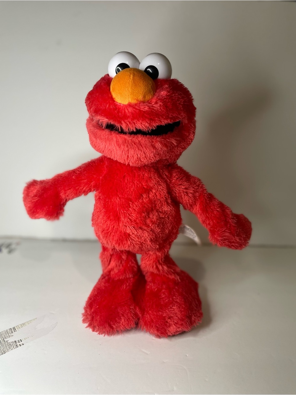 Sesame Street Elmo Slide Plush toy features both English/Spanish language modes